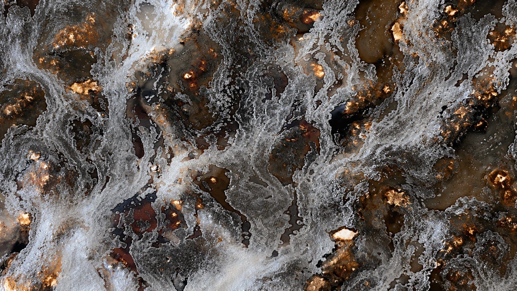 Close-up of a crystalline glaze surface with copper and silver tones